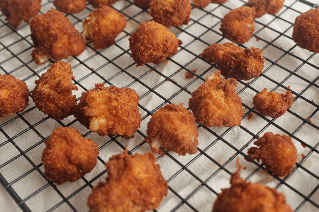 fried cauliflower on wire cooling rack 