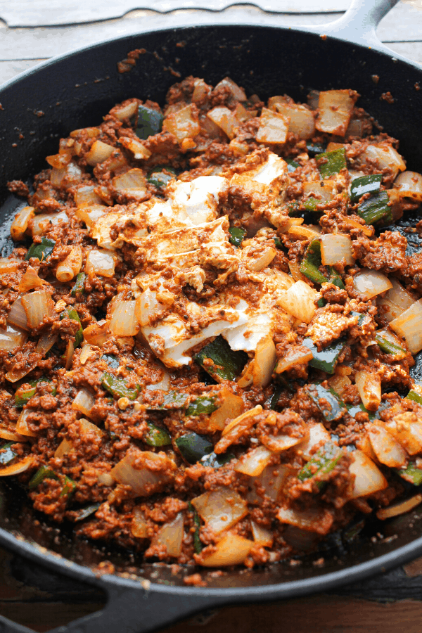 chorizo, diced white onion and poblano peppers and goat cheese in a cast iron skillet. 