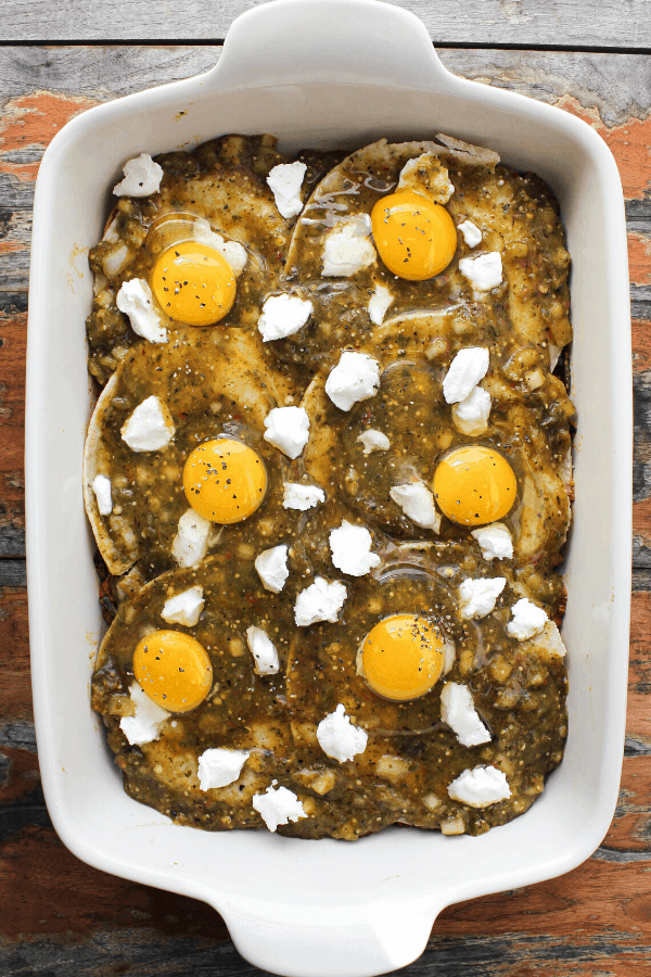 huevos rancheros casserole with raw eggs prior to cooking in white baking dish from above 