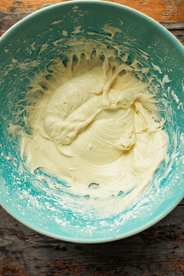 cream cheese icing in blue bowl from above 