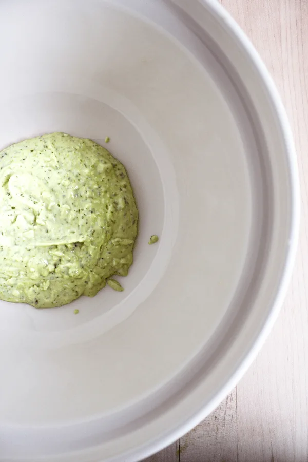 Mayo pesto sauce in white bowl shot from above.