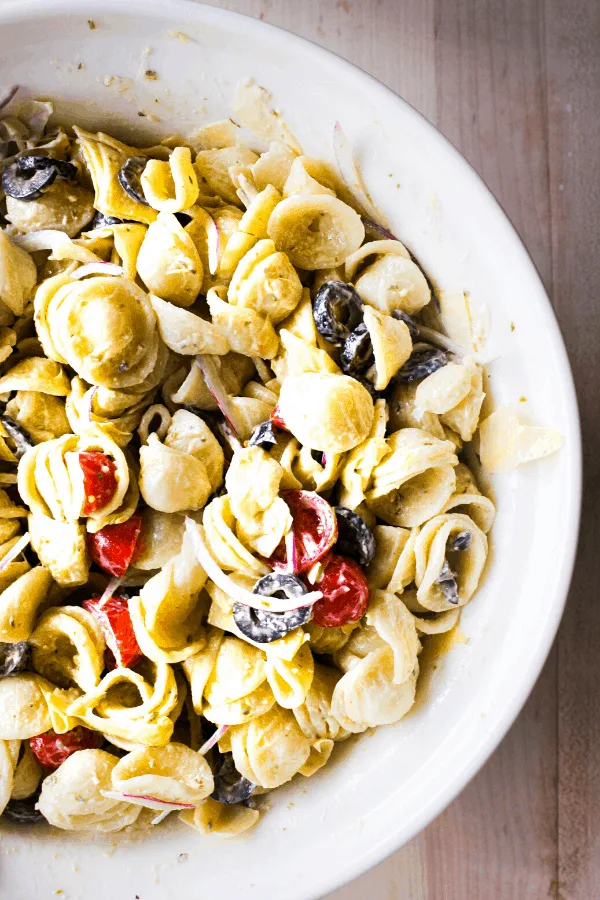 Half shot of large bowl of pasta salad shot from above.