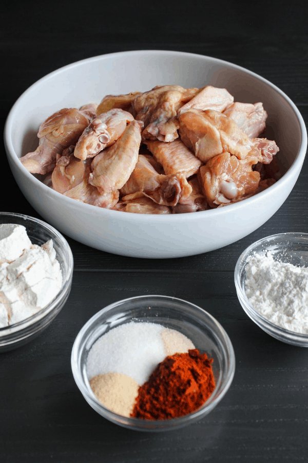 Ingredients for chicken wings on grey surface. 