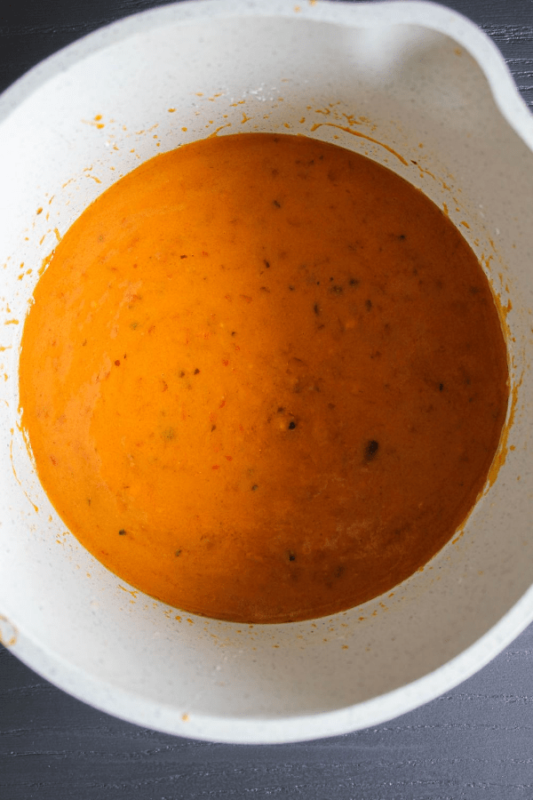 Top down shot of chile de árbol wing sauce in a small saucepan. 