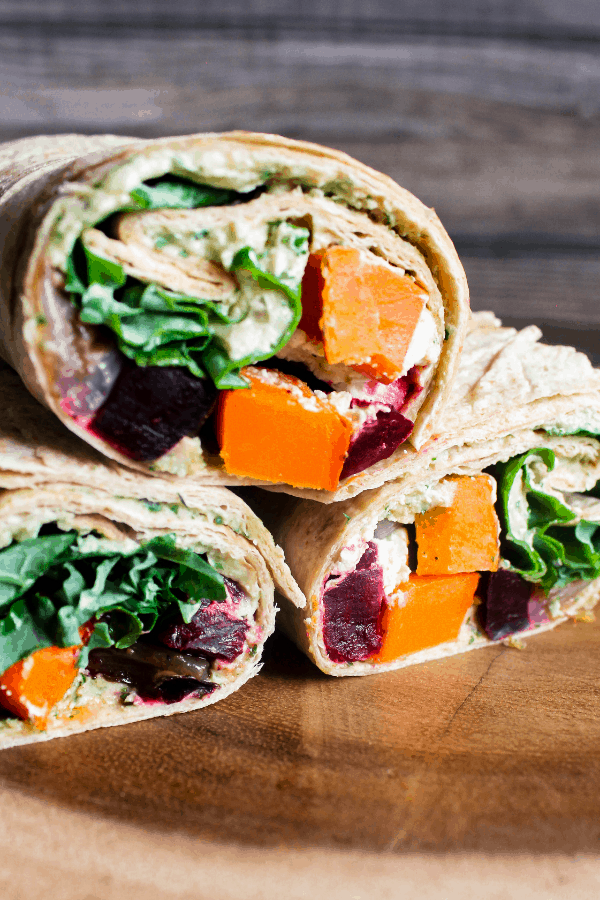 Three halves of autumn harvest vegetable wraps stacked atop one another.