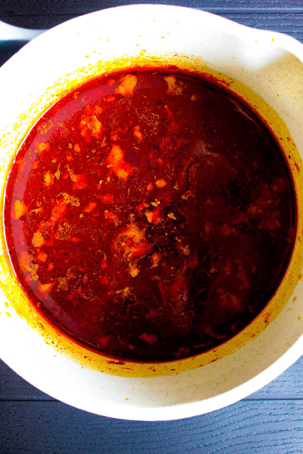 Top down shot of birria in a small saucepan.