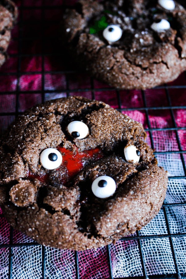 Close up of single chocolate crinkle cookie w/ zombie blood.