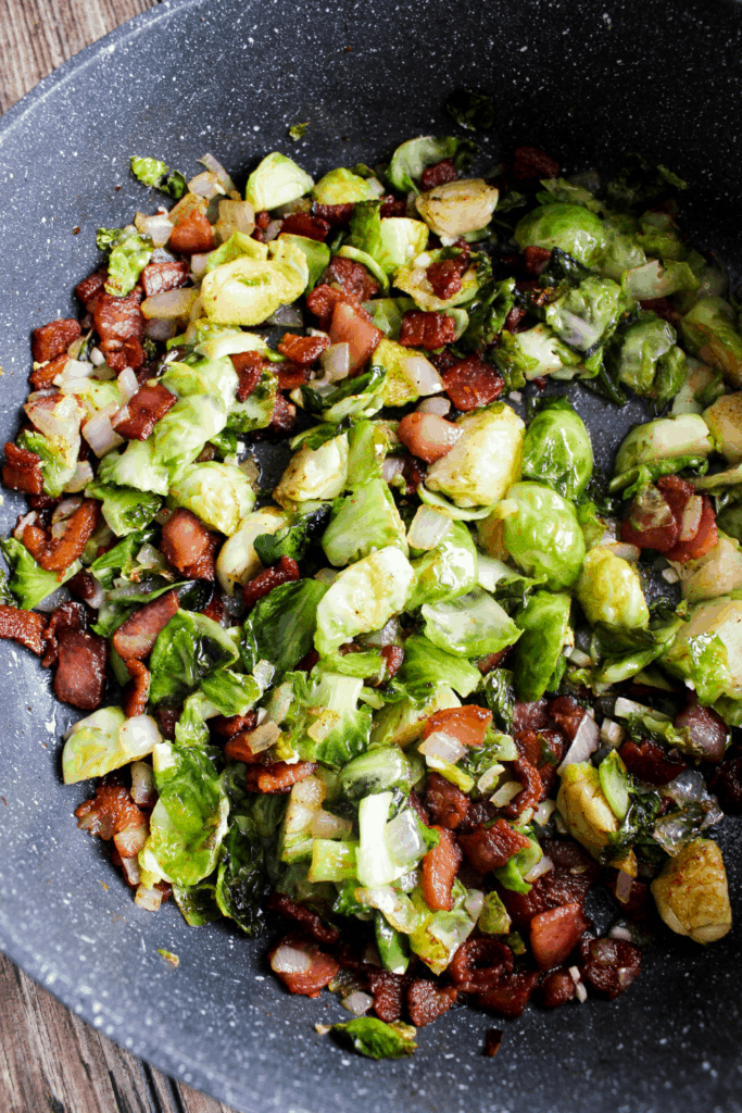 Brussels sprouts and bacon in sauté pan.