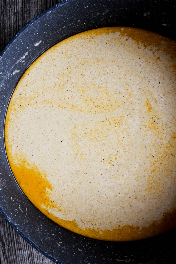 Top down shot of cheese sauce in sauté pan.