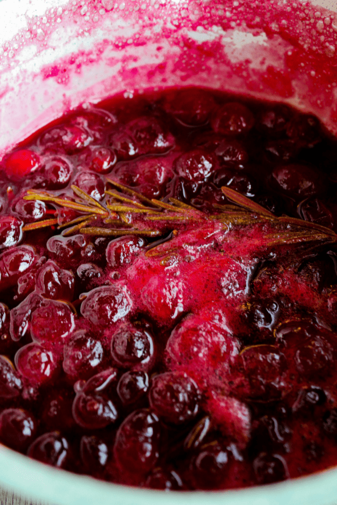 Simmer cranberries and rosemary.