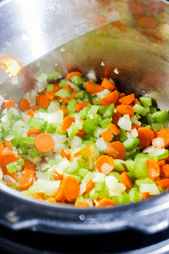 Close-up shot of sautéed vegetables in Instant Pot bowl.