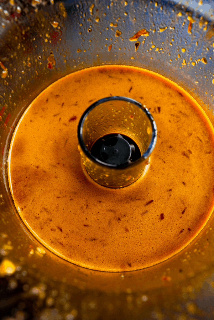 Spicy black garlic soy sauce in food processor bowl.