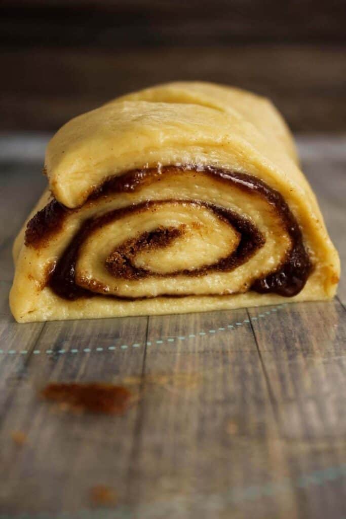 Close up of sliced cinnamon roll roll.