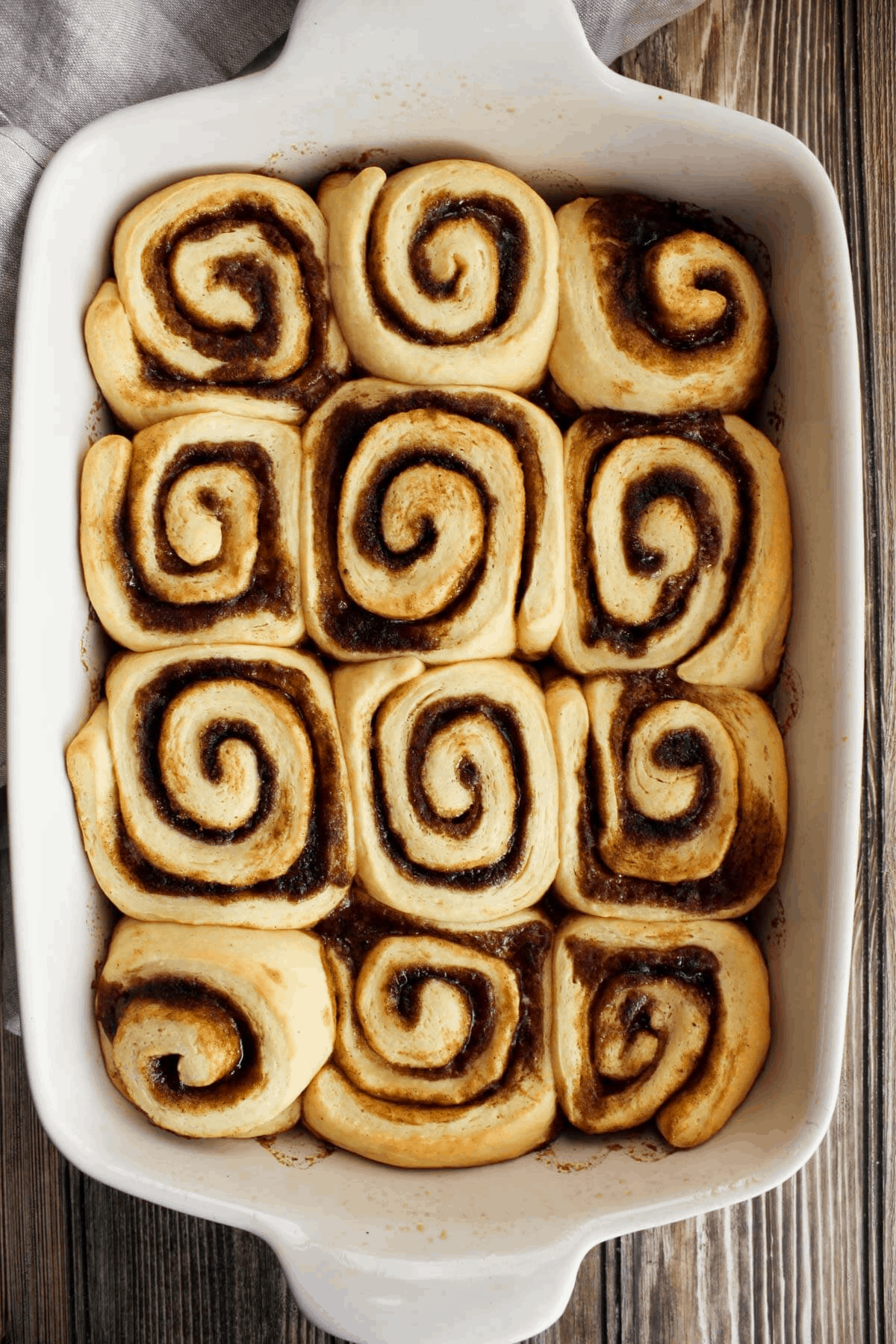 Top down shot of baked cinnamon rolls prior to icing.