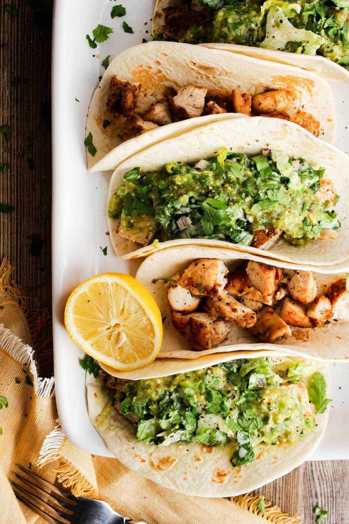 Tray of Caesar tacos with a lemon.