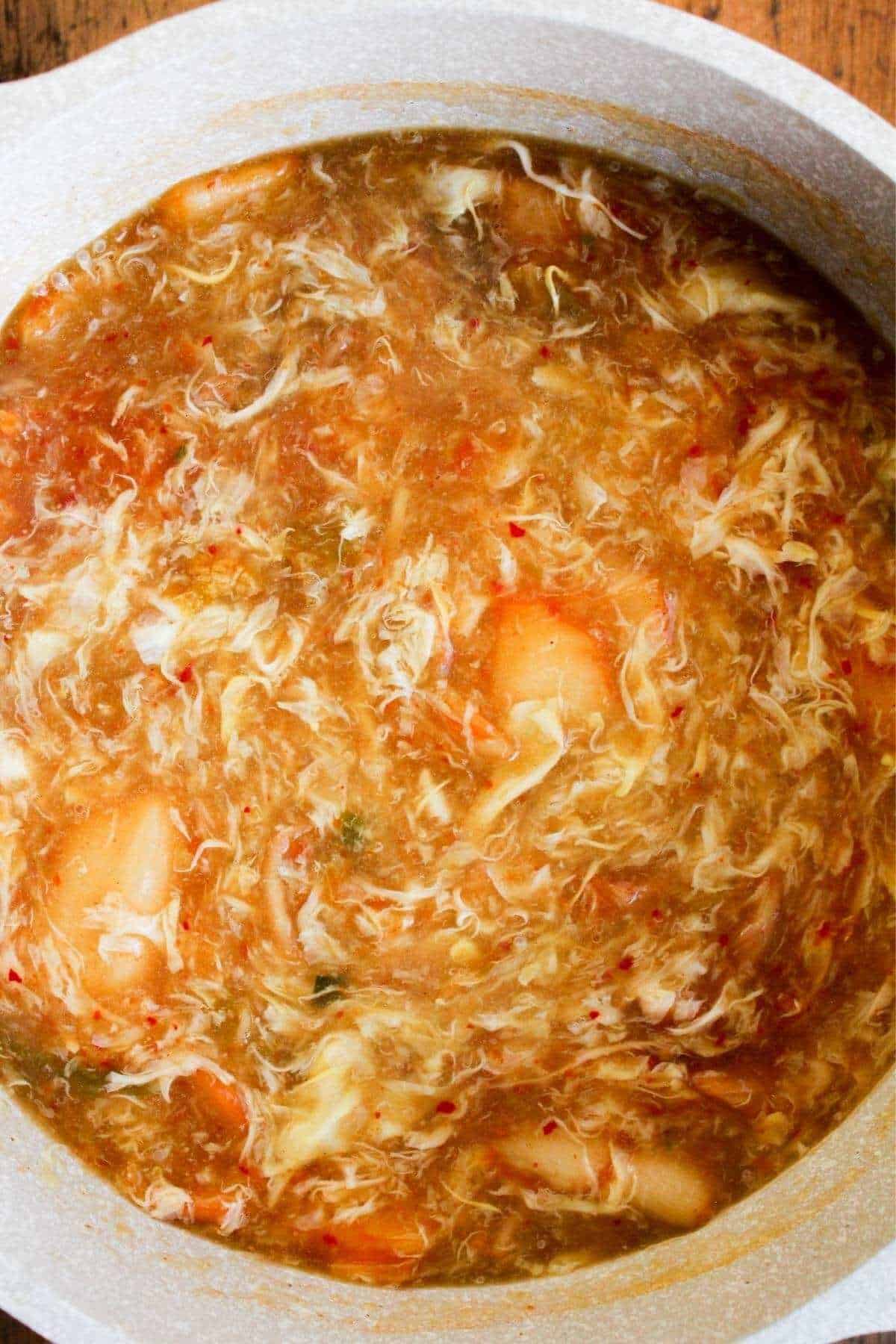 Miso egg drop soup with kimchi in a pot.