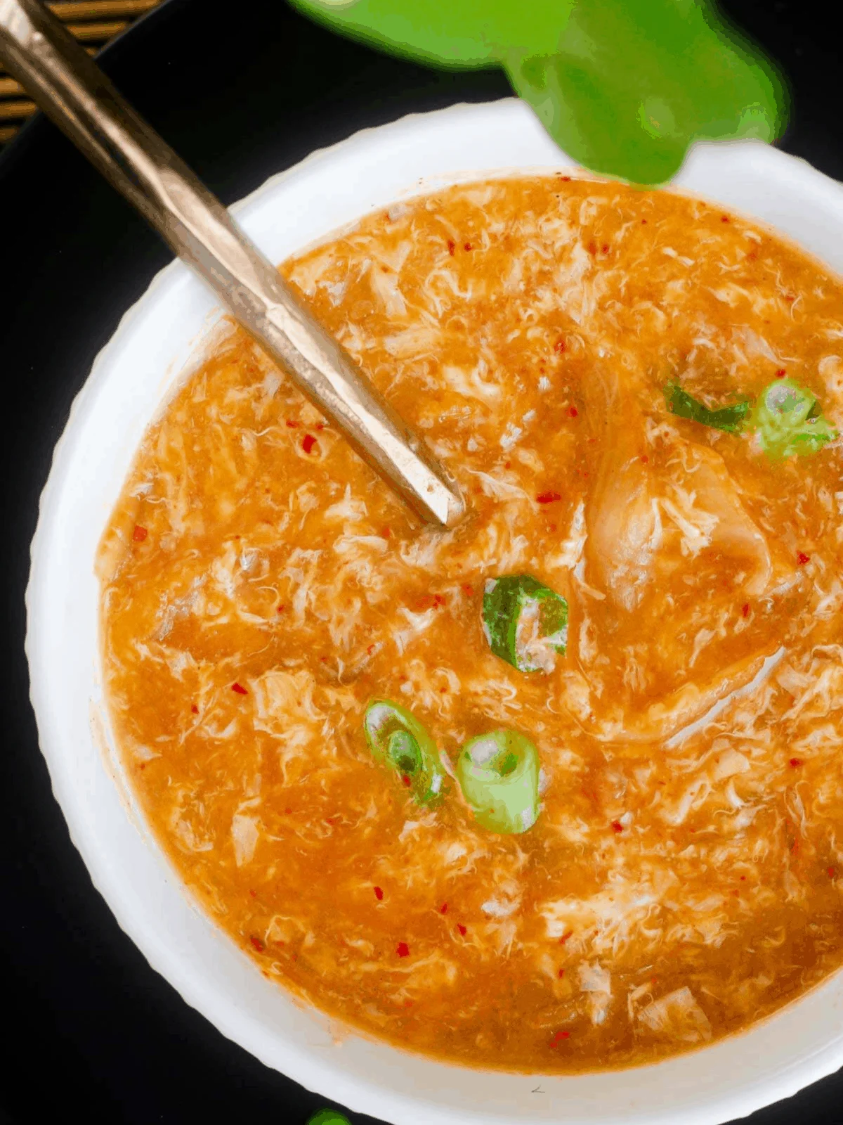 Close-up of miso egg drop soup w/ kimchi.