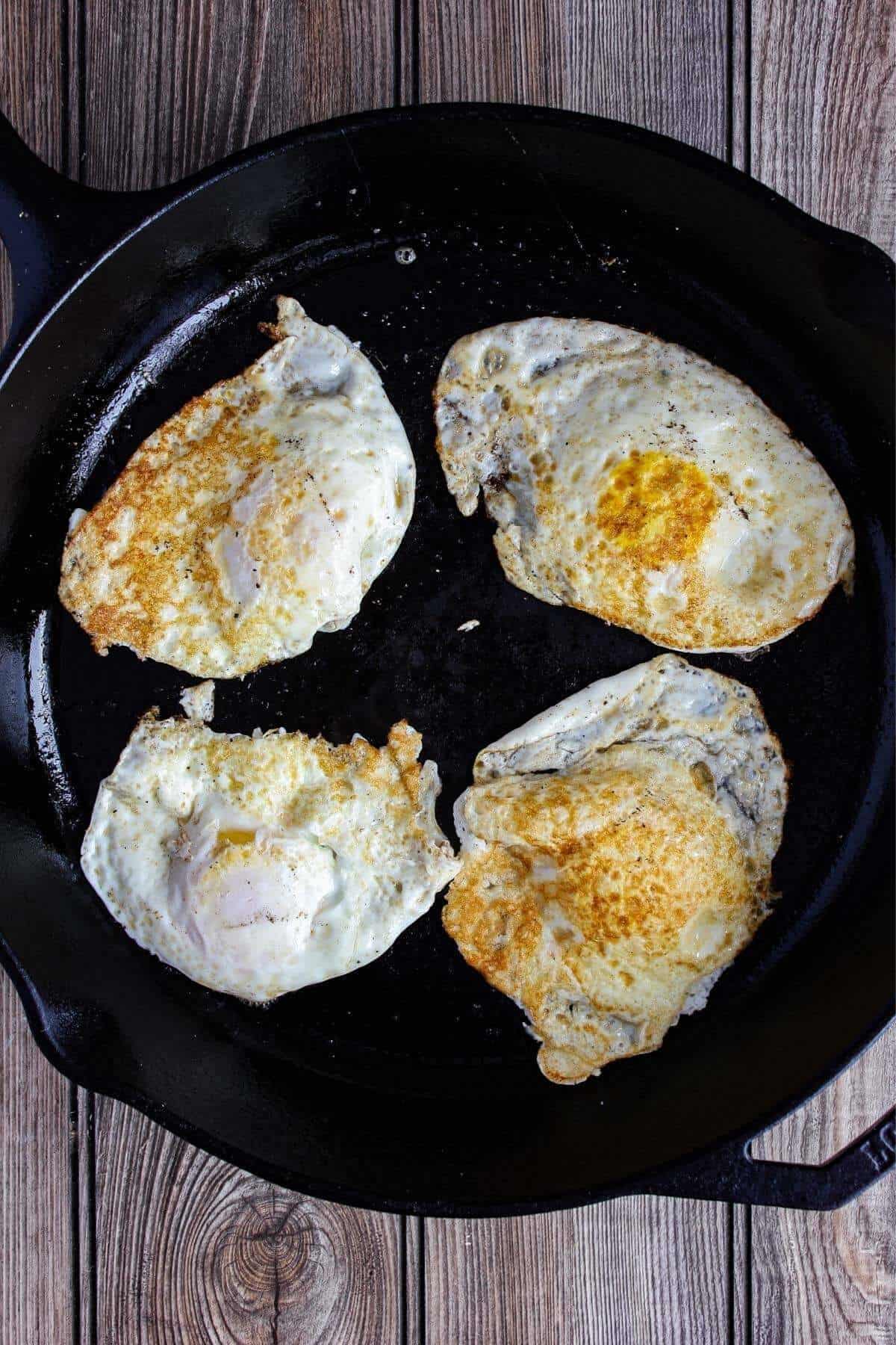 Fried eggs in a skillet.
