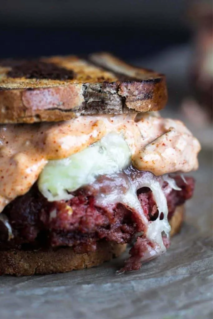 Close-up of a Reuben burger.