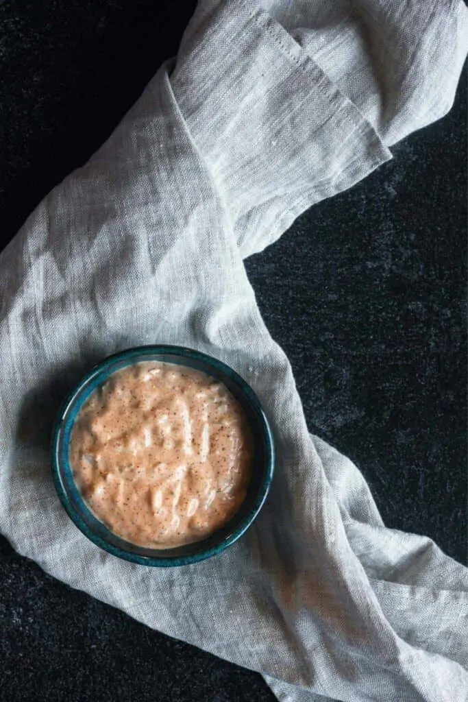 Dressing in a small blue bowl.