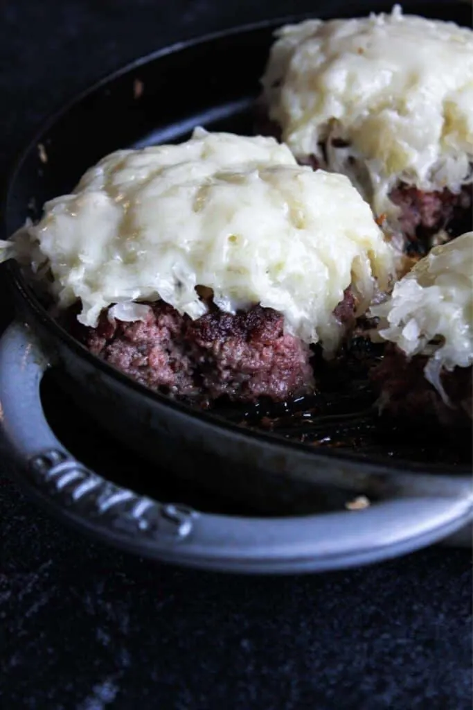 Close-up of cooked burgers in a grill pan.