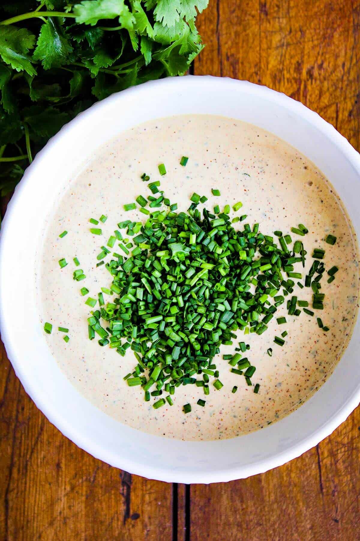 Bowl of ranch with chopped chives.
