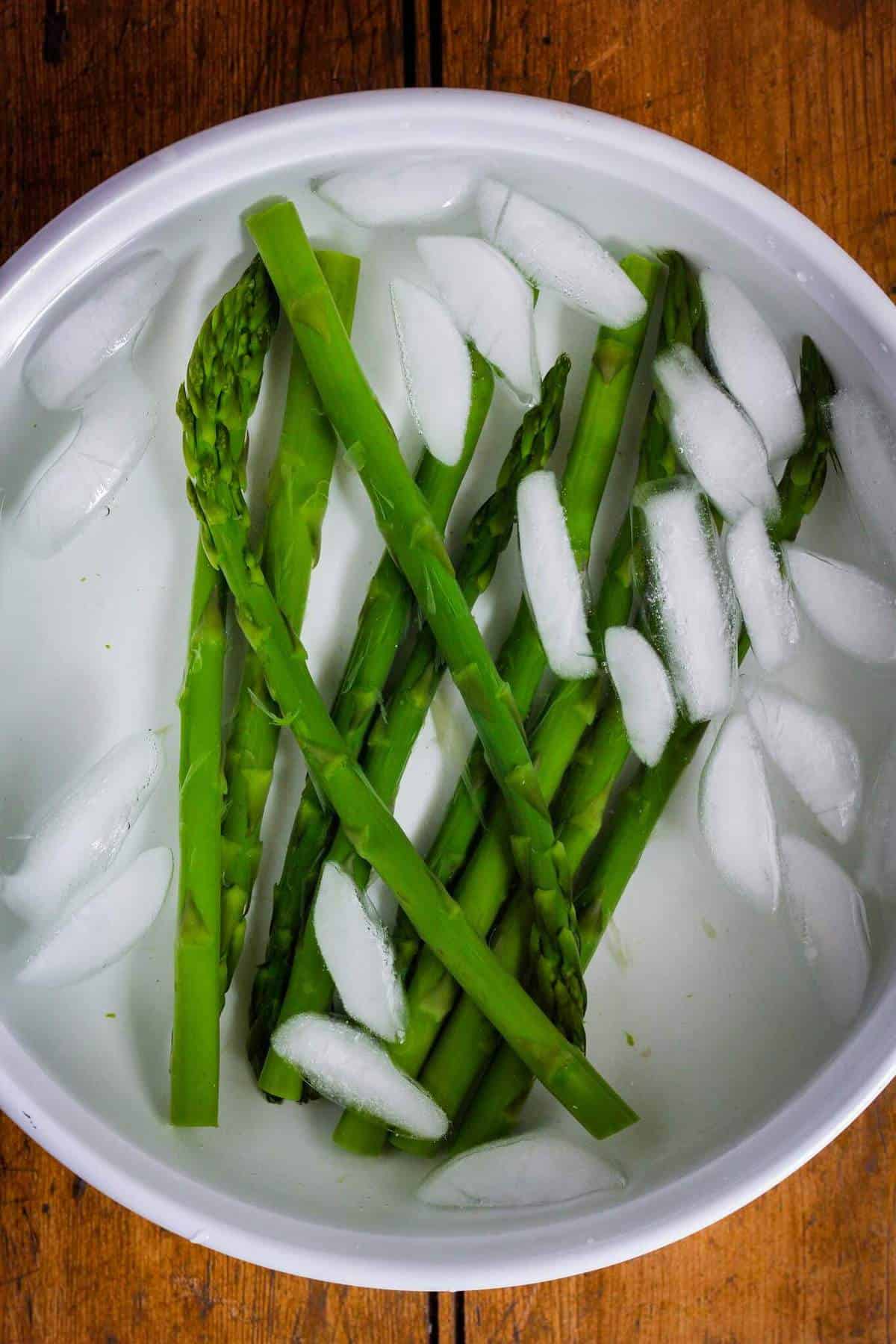 Blanched asparagus in ice water bath.