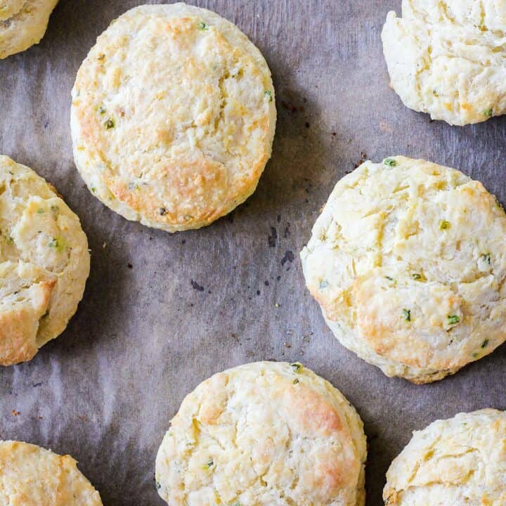 Close up of cooked biscuits on a sheet pan.