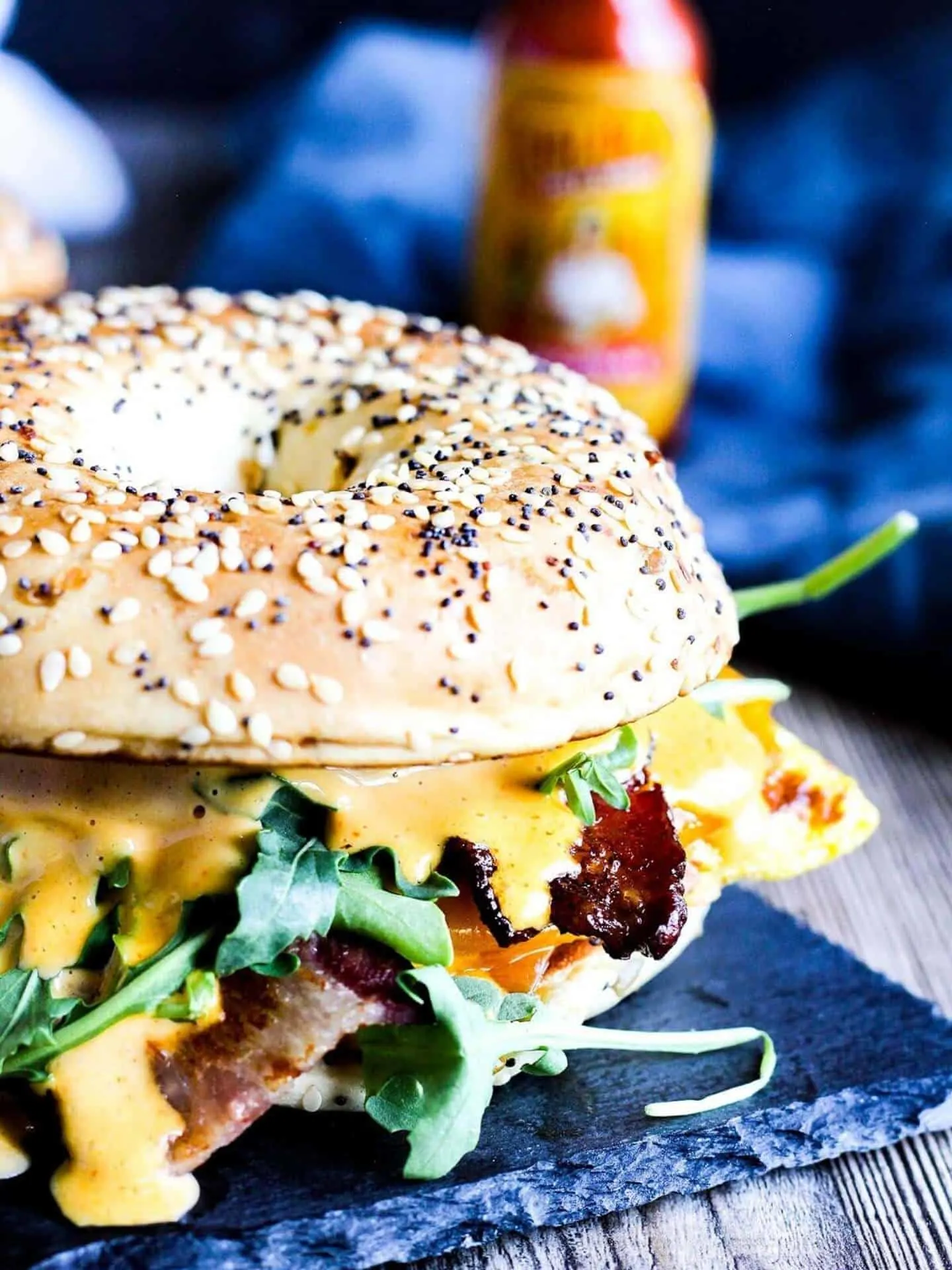 Close-up of bacon bagel sandwich.