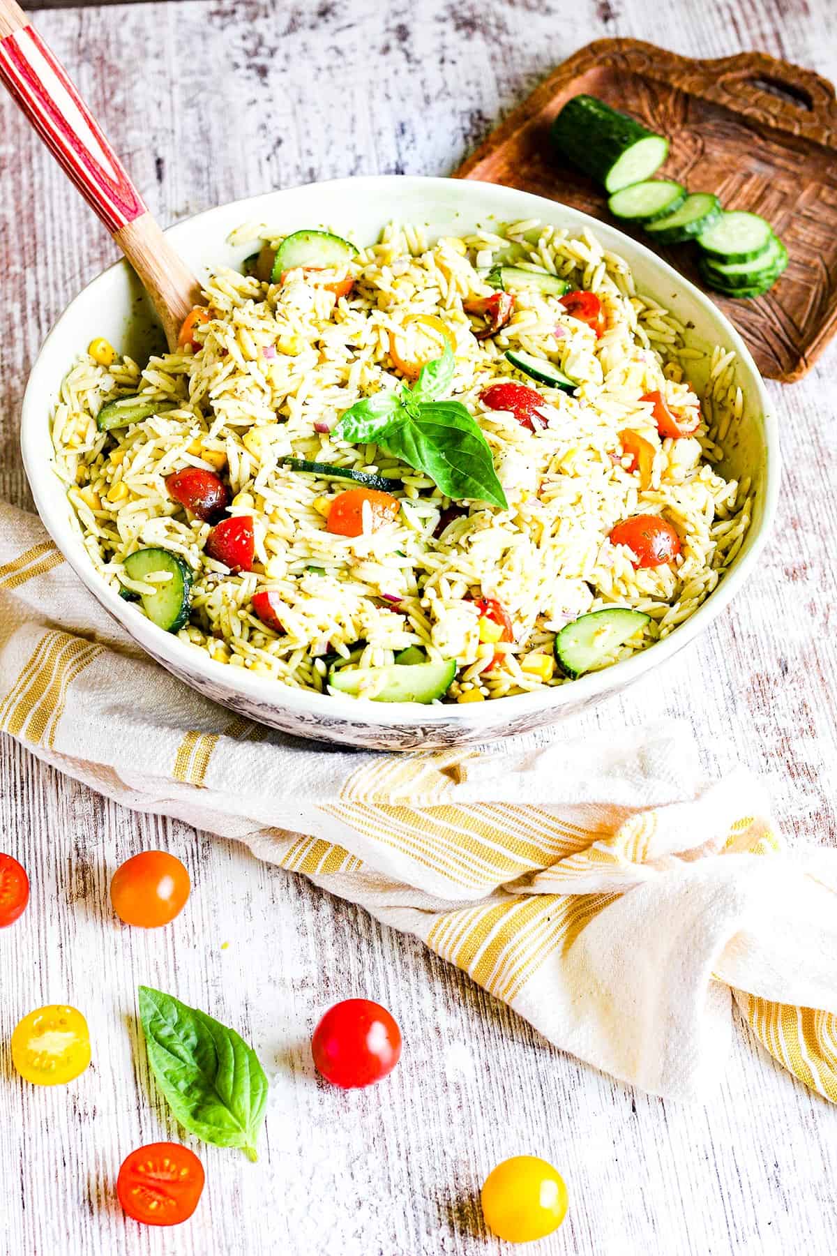 Bowl of orzo pesto salad with a spoon. 