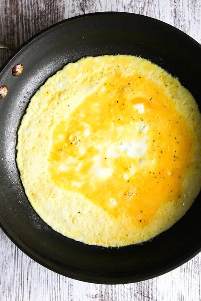 Eggs cooking in a skillet.