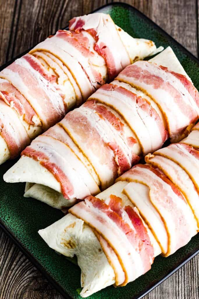 Bacon-wrapped burritos prior to cooking.