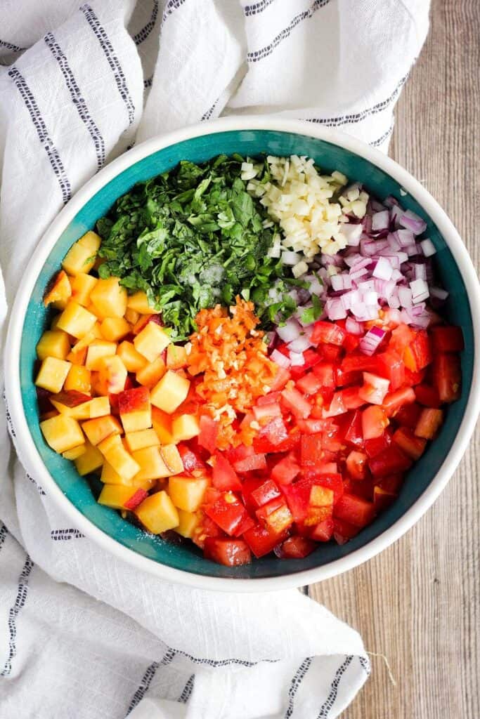Ingredients for salsa in a bowl.