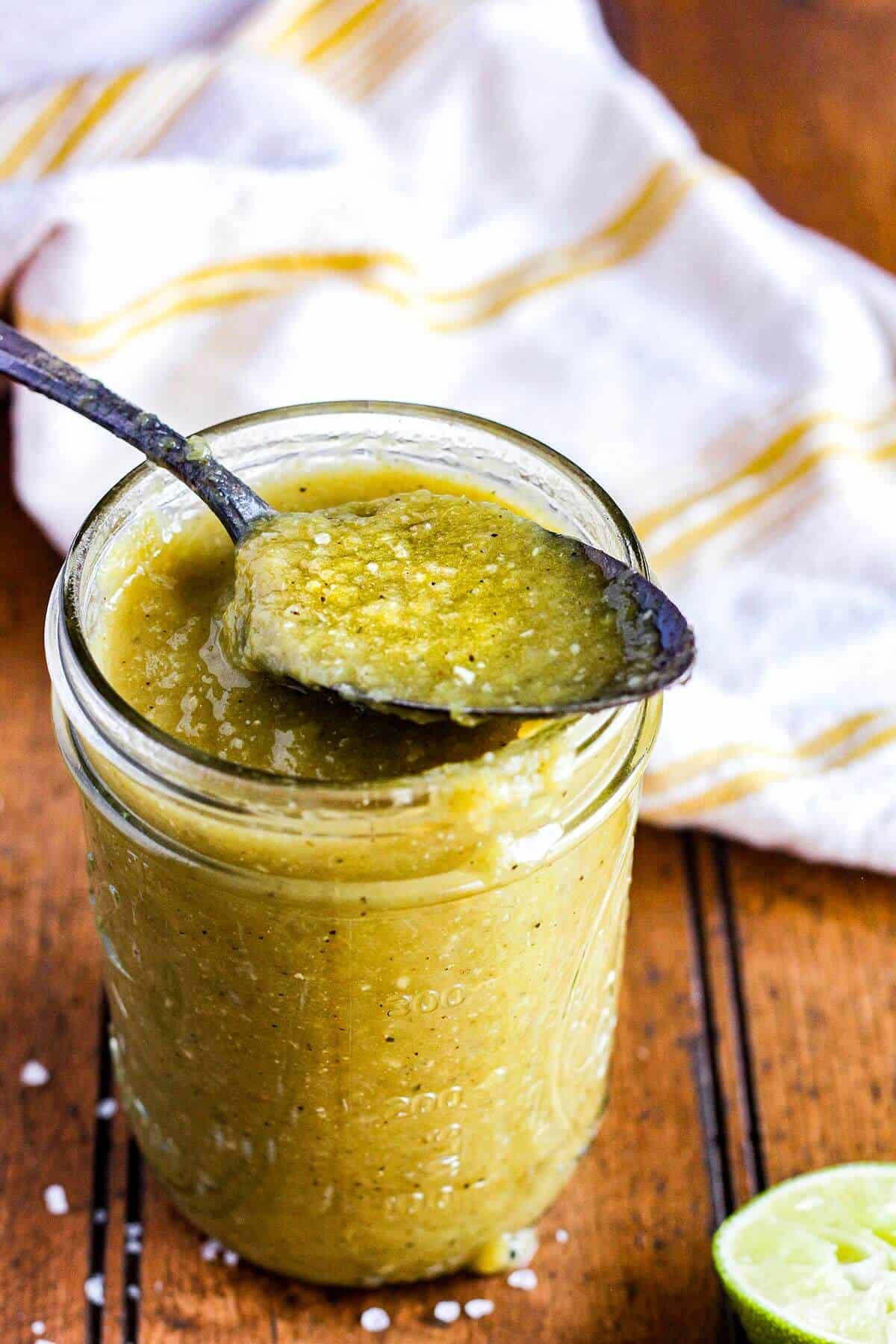 Spoonful of hatch chile enchilada sauce atop a jar.