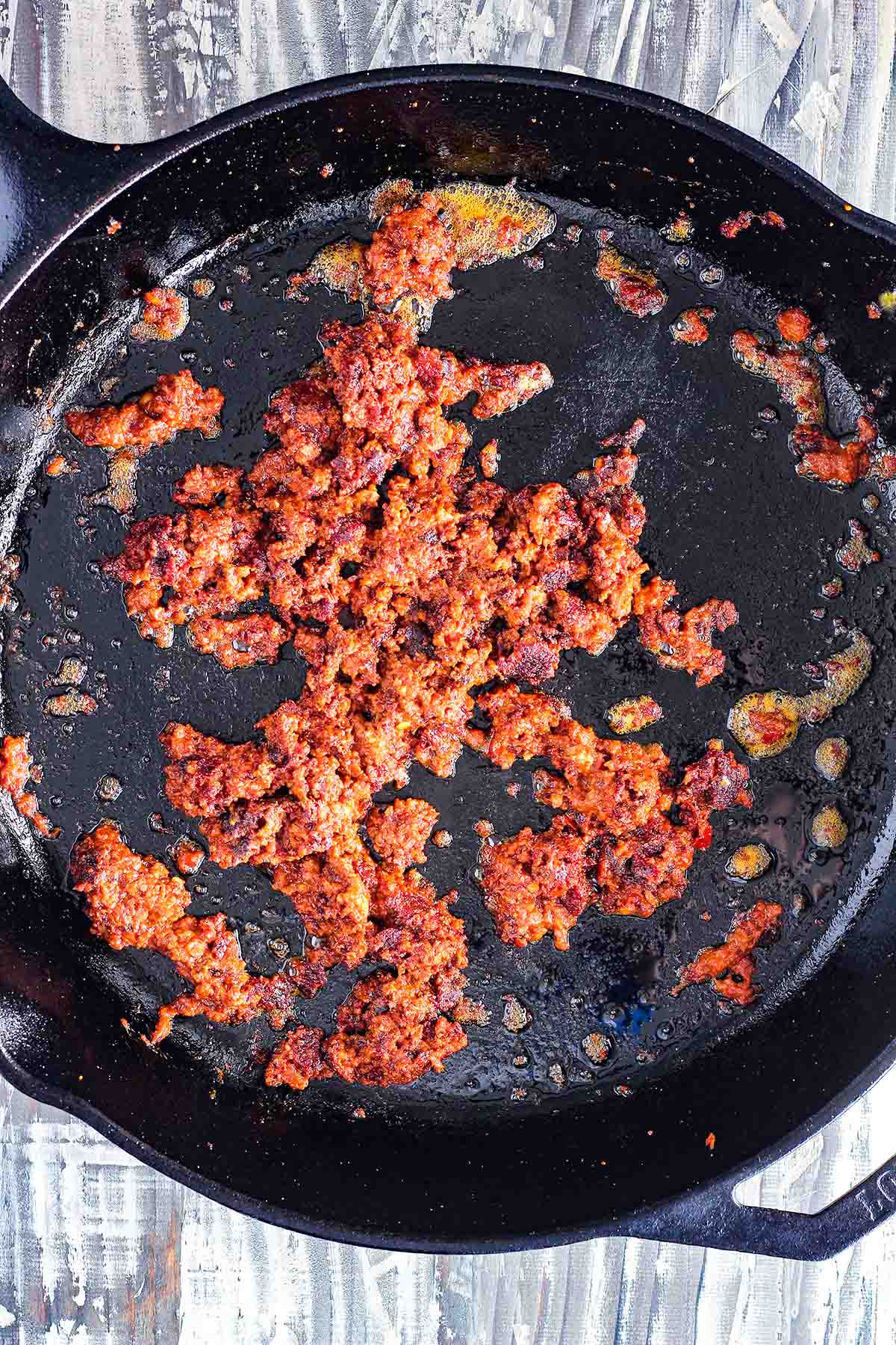Cooked chorizo in a cast-iron skillet.
