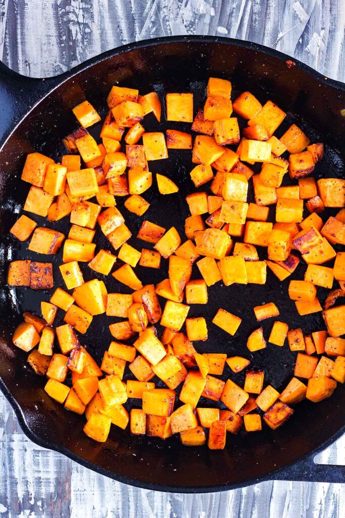 Cooked sweet potatoes in a cast-iron skillet.