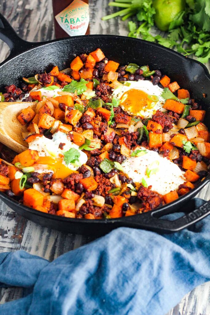 Skillet of breakfast hash with eggs.