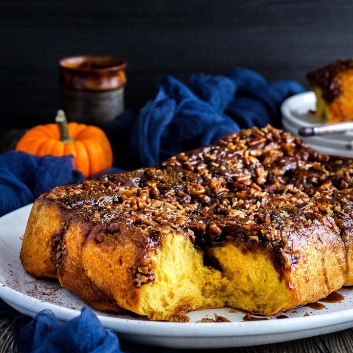 Sticky buns with fall decor in background.