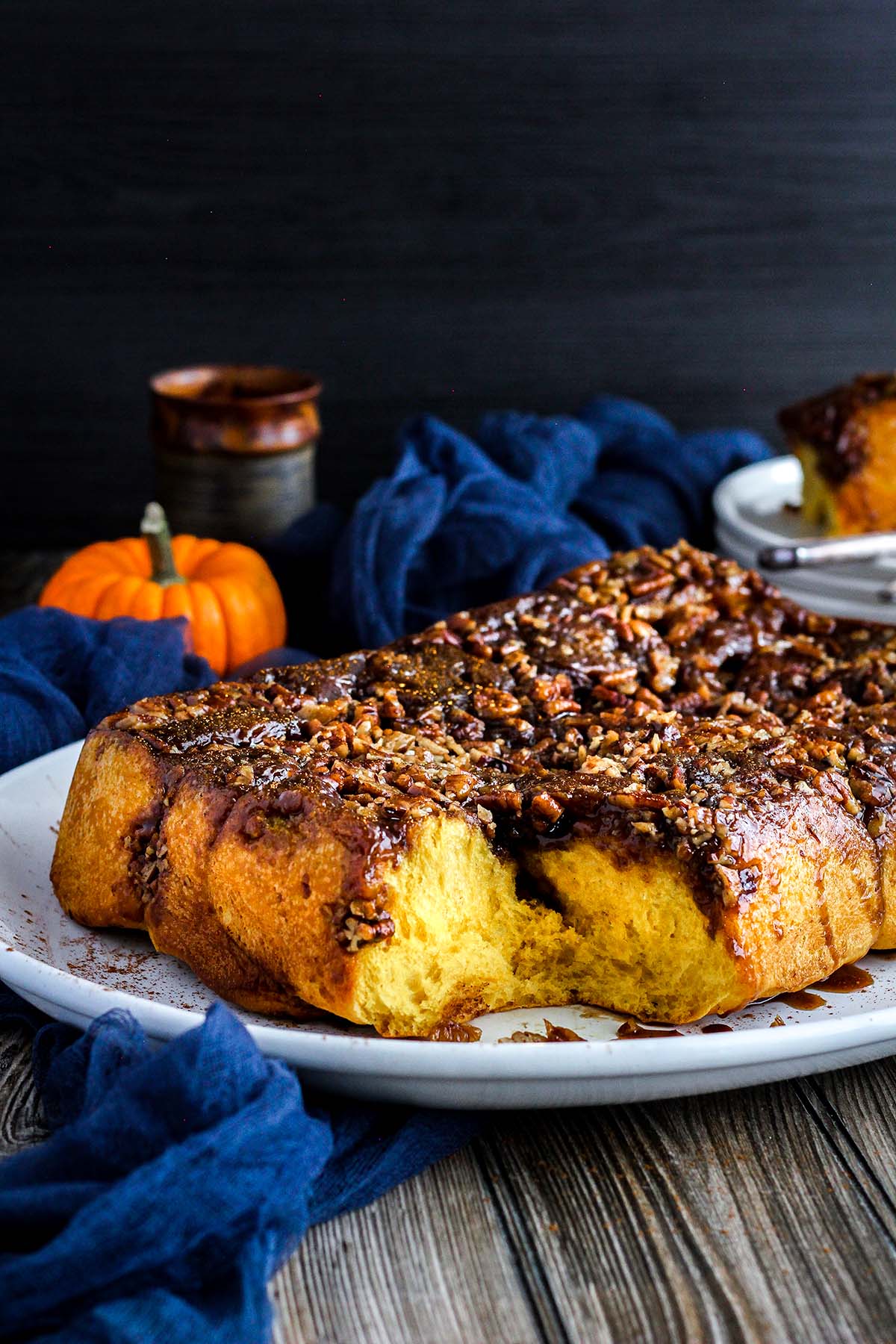 Sticky buns with fall decor in background.