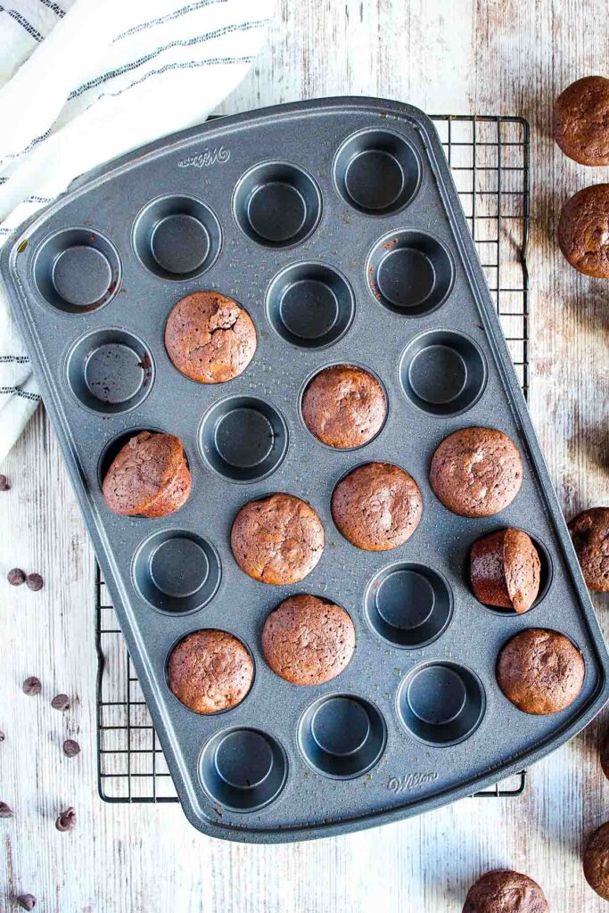 Muffin pan partially filled with brownies.