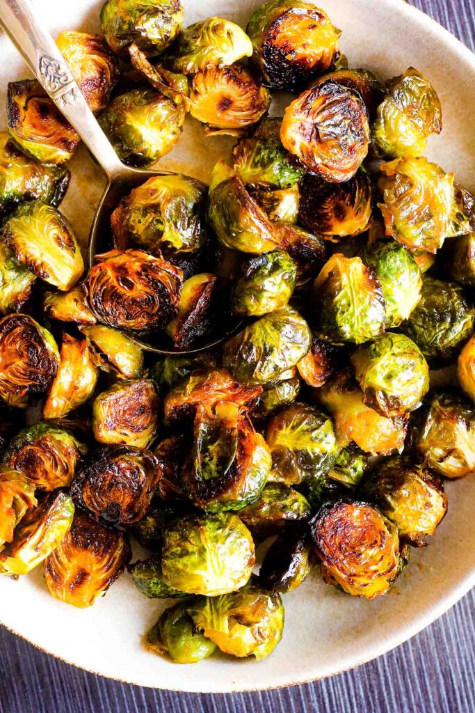Bowl of sriracha Brussels sprouts with honey.
