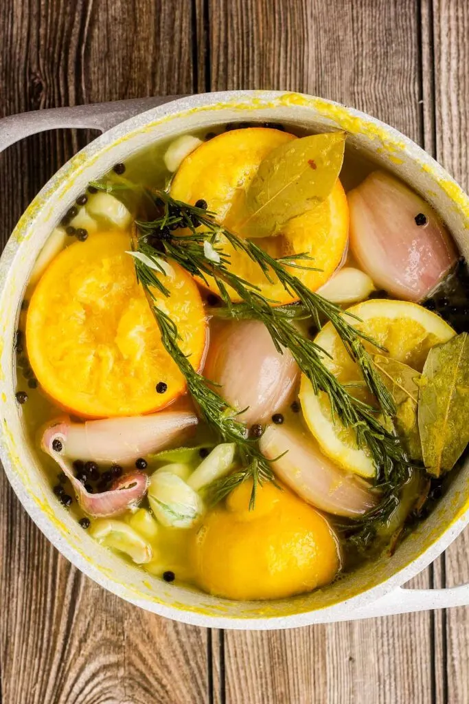 Boiled orange brine in a saucepan.