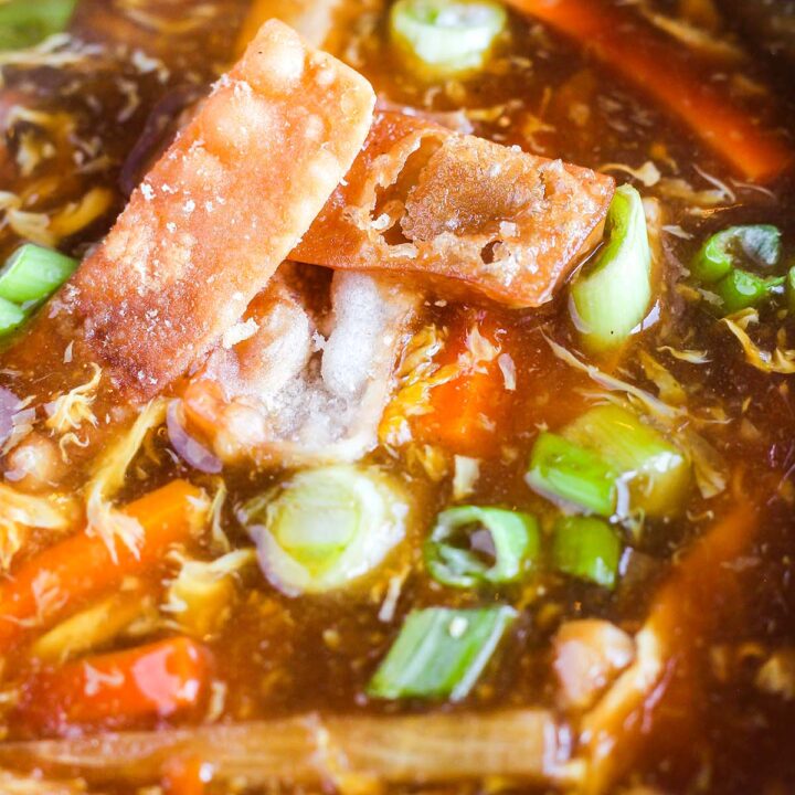 Close up of hot and sour soup in a blue bowl.