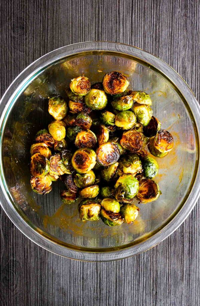 Honey sriracha Brussels sprouts in a glass bowl.