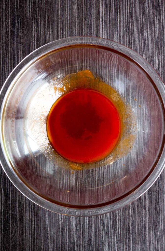 Honey sriracha sauce in a glass bowl.