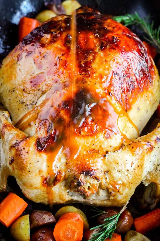 Juices being poured on to chicken.