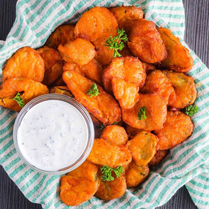 Bowl of buffalo fried pickles with a small bowl of ranch