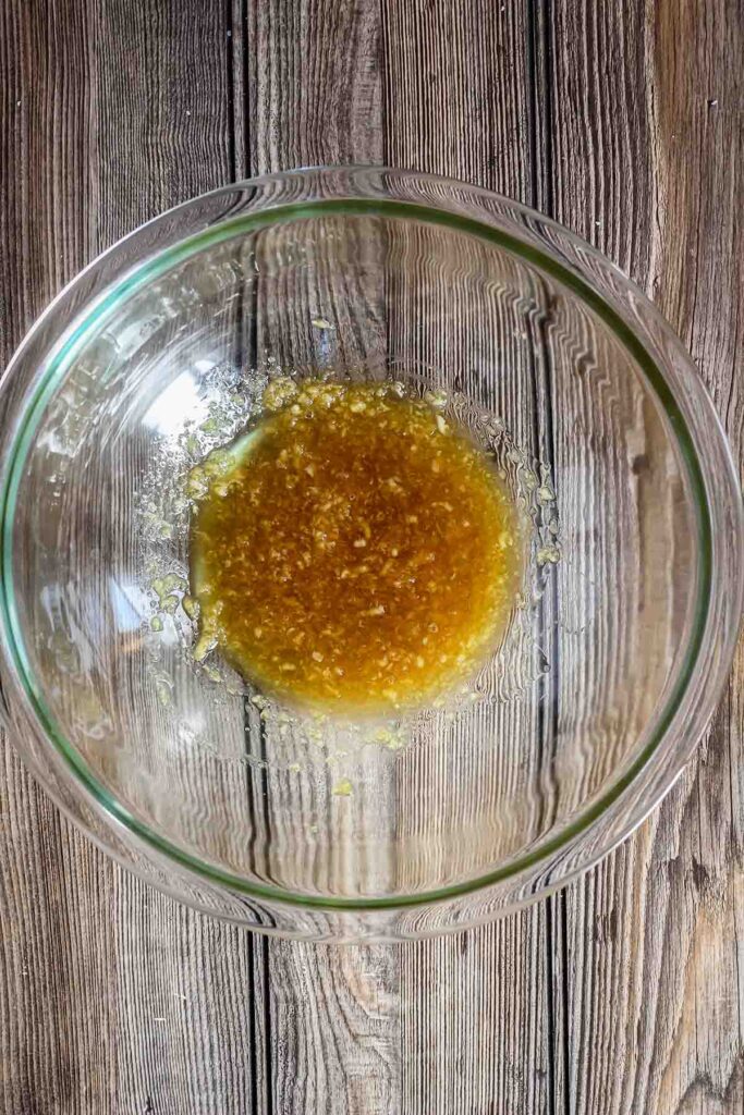 Honey garlic ginger sauce in a clear bowl.