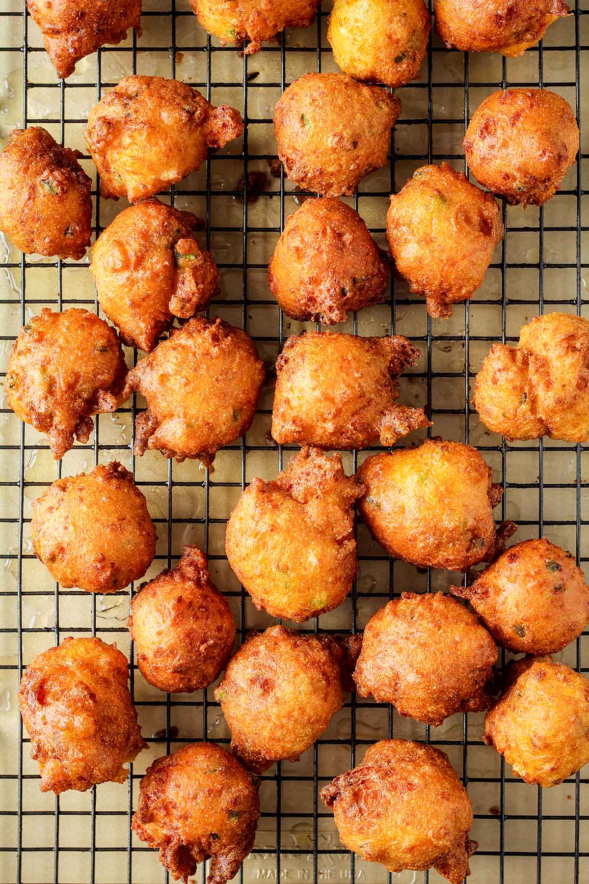 Jalapeno hush puppies on a wire cooling rack