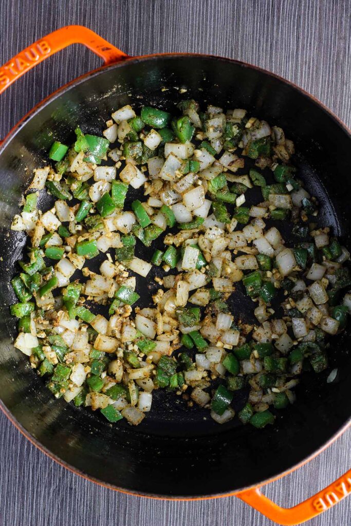 Sauteed onions and jalapenos in a Dutch oven